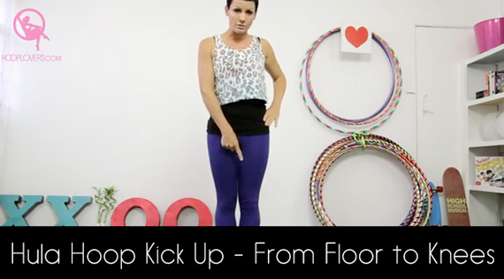 Kick up a hula hoop from a floor.